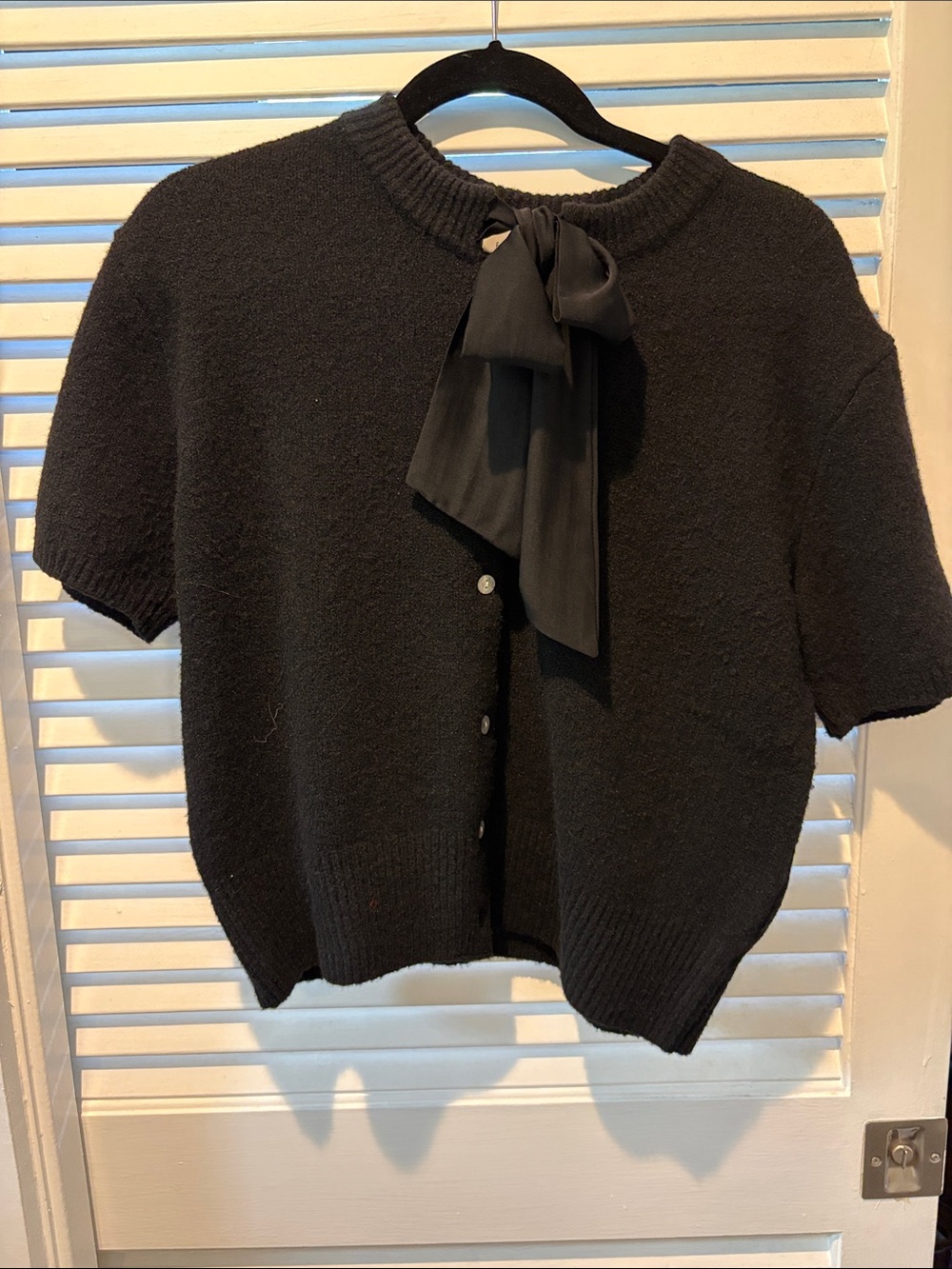 Free Assembly short sleeve sweater with bow neck detail